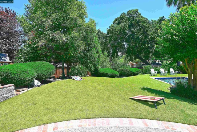 a front view of house with yard and outdoor seating