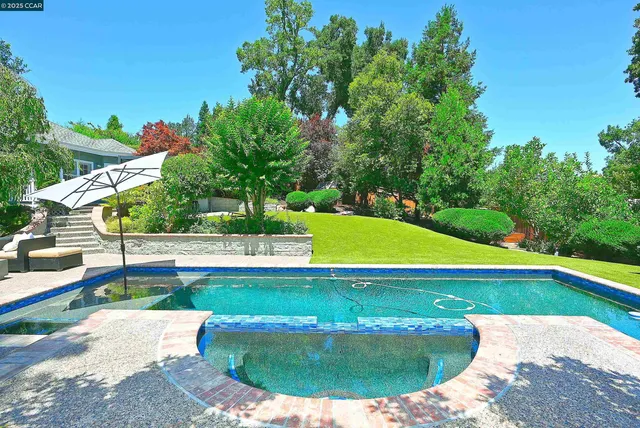 a view of a swimming pool with a patio