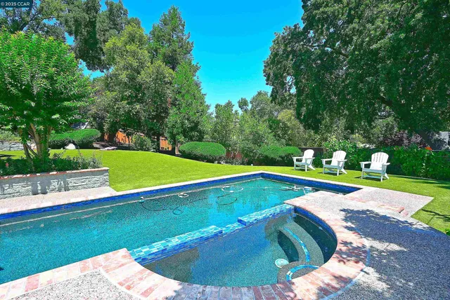 a view of a backyard with a patio and fire pit