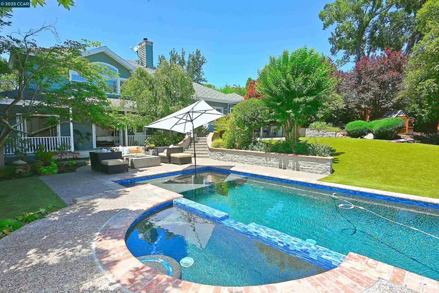 a view of a house with a backyard and a tree