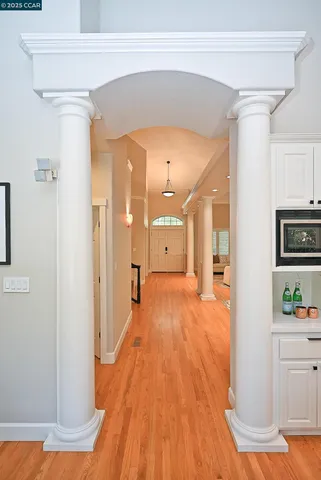 a view of a hallway with wooden floor windows and livingroom