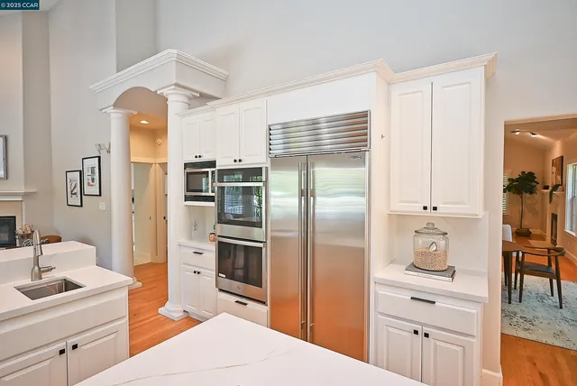 a kitchen with stainless steel appliances a refrigerator sink and cabinets