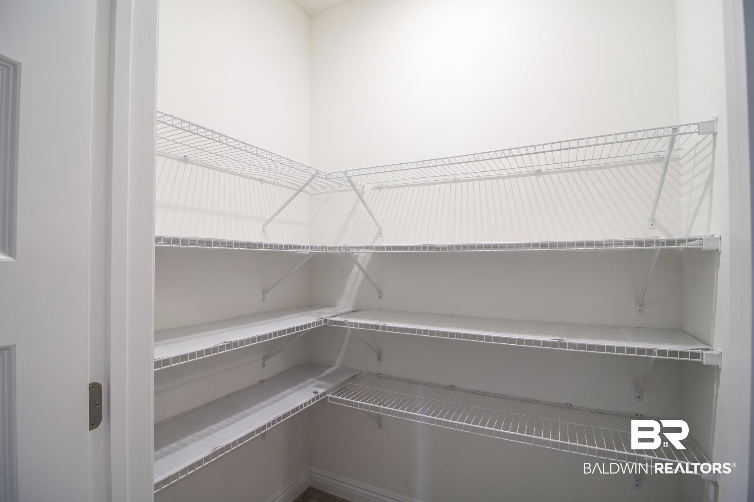 1885 Carly Street Foley, AL 36535 - Photo 12 of 40 Walk-in pantry featuring white wire shelving, multiple levels of storage, and white walls