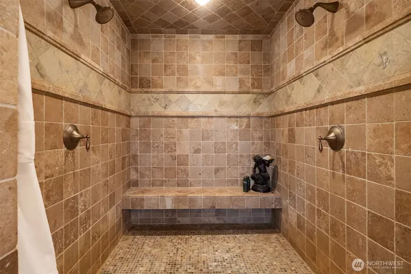 a bathroom with a granite countertop sink a large mirror and a bathtub