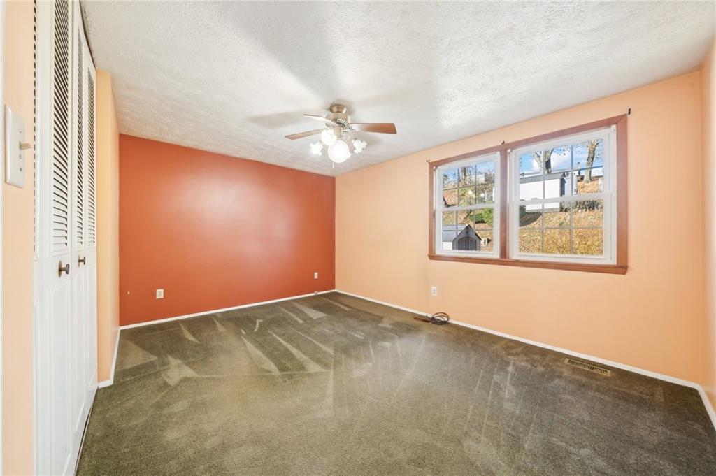 1828 Ivanhoe Drive Irwin, PA 15642 - Photo 13 of 33 an empty room with windows and ceiling fan