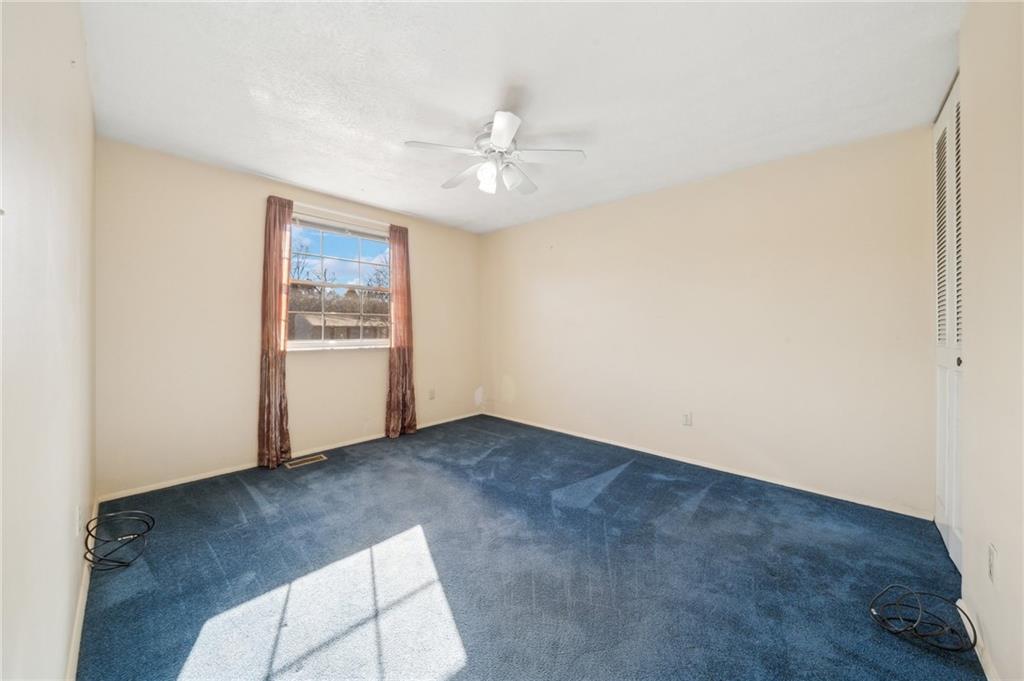 1828 Ivanhoe Drive Irwin, PA 15642 - Photo 14 of 33 an empty room with windows and ceiling fan