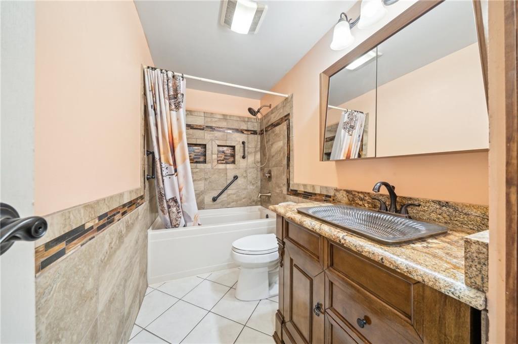 1828 Ivanhoe Drive Irwin, PA 15642 - Photo 18 of 33 a spacious bathroom with a granite countertop sink a toilet a mirror and shower