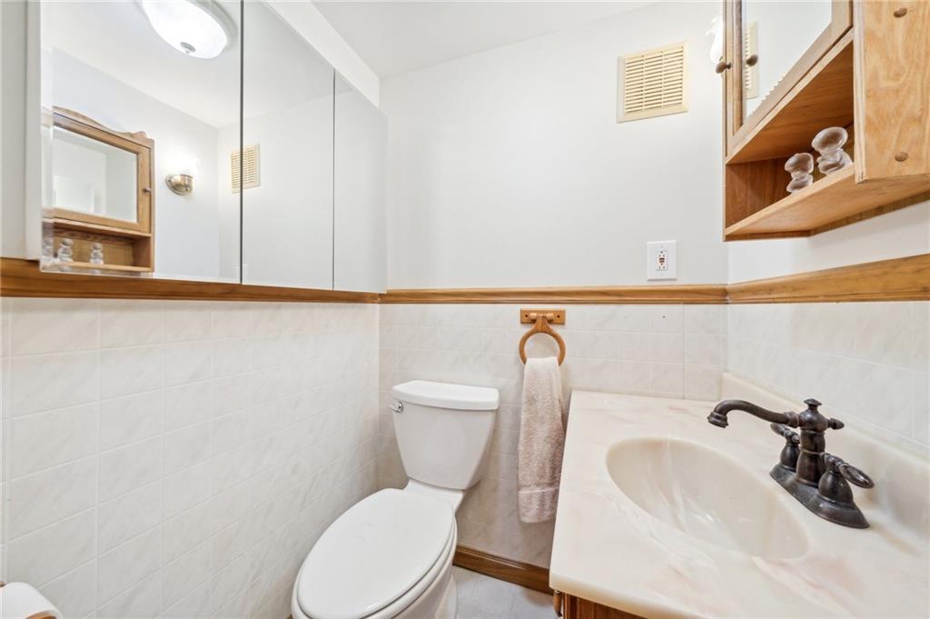 1828 Ivanhoe Drive Irwin, PA 15642 - Photo 22 of 33 a white toilet sitting next to a bathroom sink