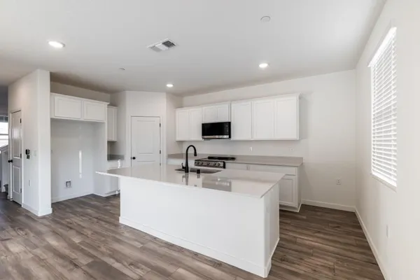 a kitchen with stainless steel appliances a sink stove and cabinets