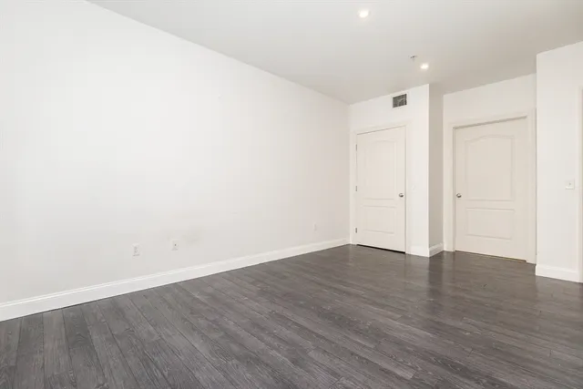 an empty room with wooden floor