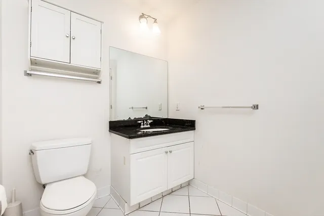 a white toilet sitting next to a sink