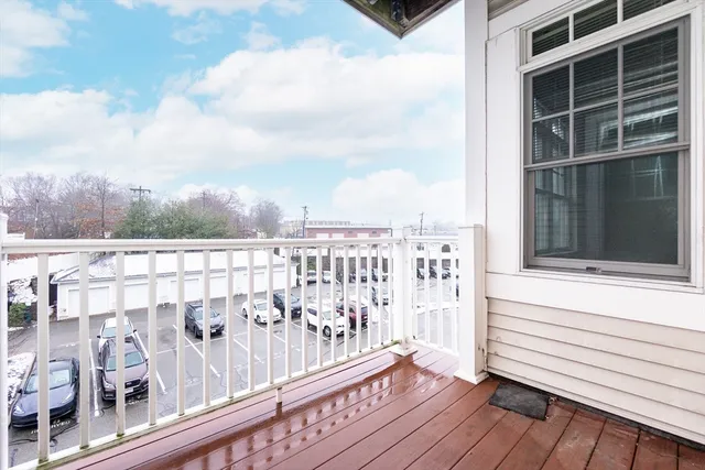 a view of a balcony with wooden floor