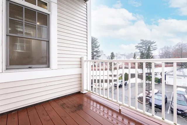 a view of a balcony with wooden floor and fence