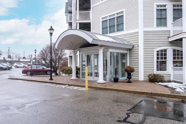 a couple of cars parked in front of a building