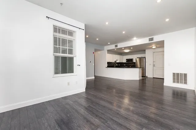 a view of a kitchen with a refrigerator and a window