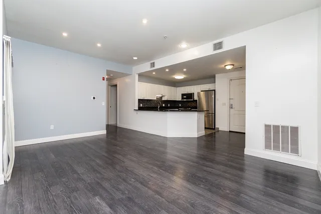 a view of kitchen with a sink and a refrigerator