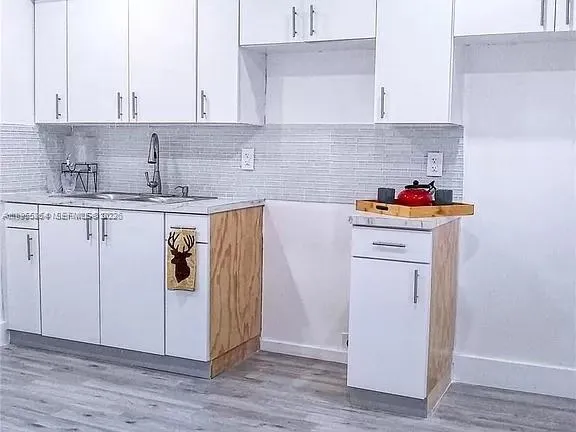 a kitchen with a sink and cabinets