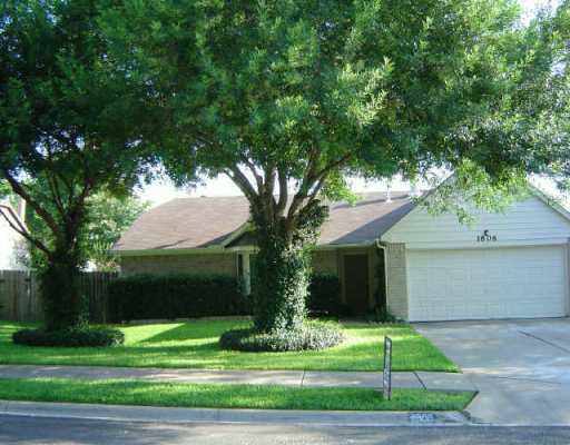 1606 Quail Run Road Pflugerville, TX 78660 - Photo 1 of 1 a front view of a house with a yard and garage