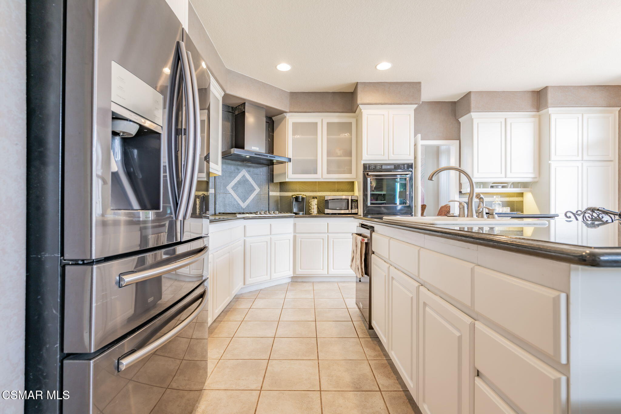 15591 Harte Lane Moorpark, CA 93021 - Photo 11 of 52 a kitchen with stainless steel appliances granite countertop a refrigerator and a sink