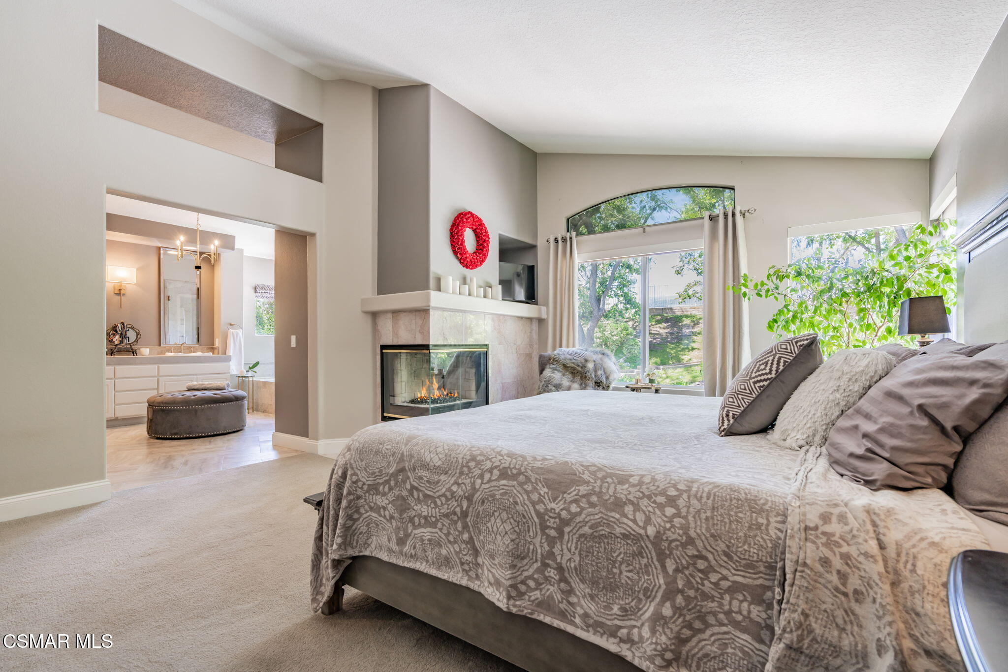 15591 Harte Lane Moorpark, CA 93021 - Photo 18 of 52 a bedroom with a bed a potted plant and a fireplace