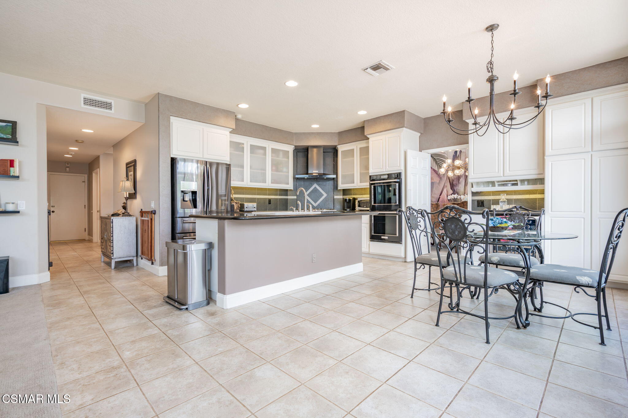 15591 Harte Lane Moorpark, CA 93021 - Photo 10 of 52 a kitchen with stainless steel appliances kitchen island granite countertop a refrigerator and a cabinets