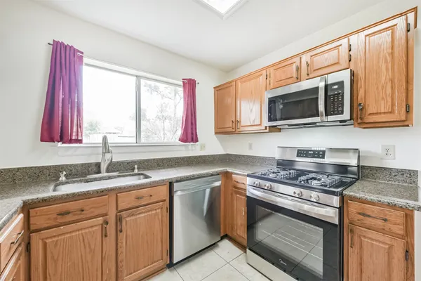 a kitchen with stainless steel appliances granite countertop a sink and a microwave