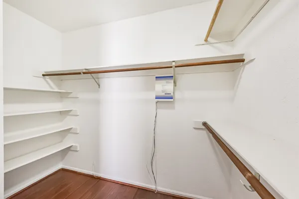 a view of walk in closet with empty racks