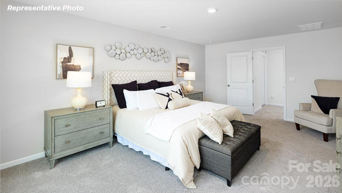 7612 Bainbridge Road Sherrills Ford, NC 28673 - Photo 19 of 37 a spacious bedroom with a bed and a couch