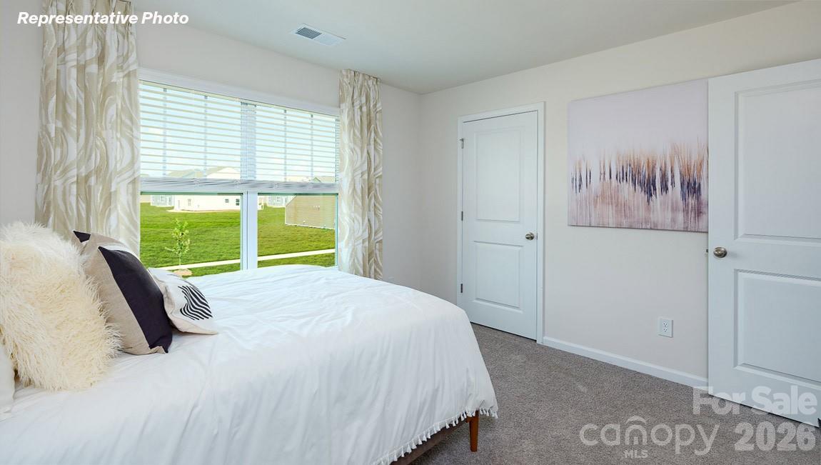 7612 Bainbridge Road Sherrills Ford, NC 28673 - Photo 28 of 37 a bed sitting in a bedroom next to a window