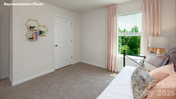 a bedroom with bed and a window