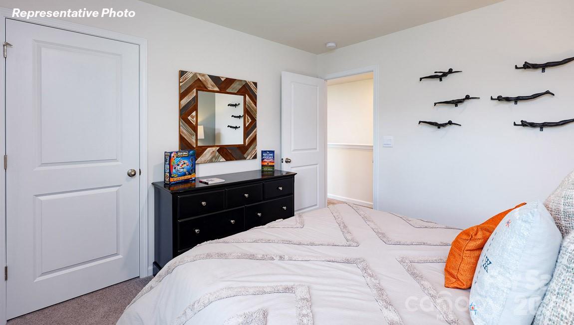 7612 Bainbridge Road Sherrills Ford, NC 28673 - Photo 32 of 37 a bedroom with a bed and a dresser in it