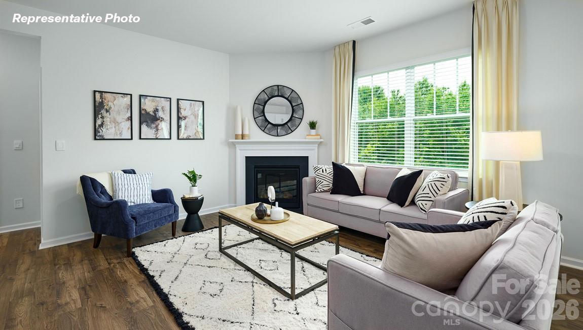 7612 Bainbridge Road Sherrills Ford, NC 28673 - Photo 10 of 37 a living room with furniture a fireplace and a floor to ceiling window