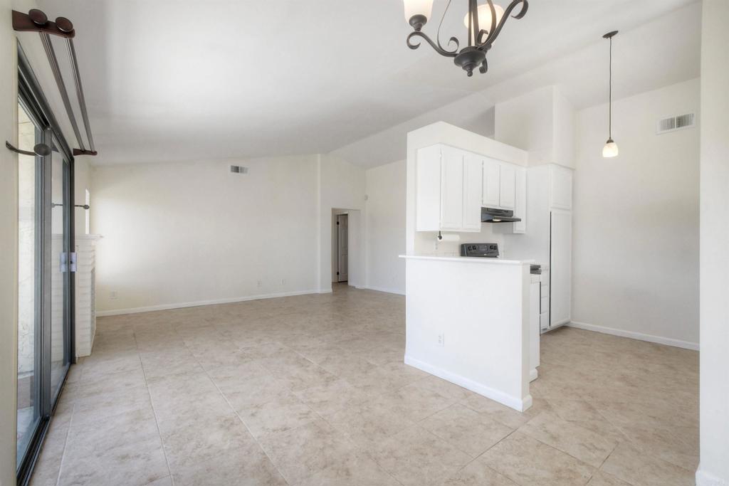 1394 Longfellow Road Vista, CA 92081 - Photo 14 of 50 a view of a kitchen with a sink and dishwasher a refrigerator with white cabinets