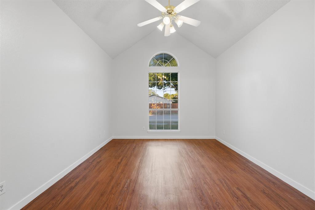 3721 Smartt Street Rowlett, TX 75088 - Photo 9 of 27 a view of an empty room with wooden floor and a window