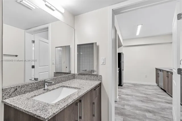 a kitchen with granite countertop a sink and stainless steel appliances
