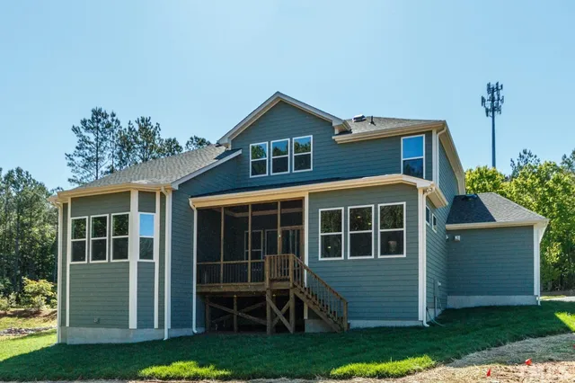 a front view of a house with a yard and potted plants