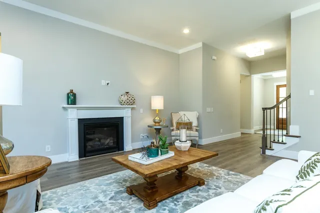 a living room with furniture a fireplace and a table