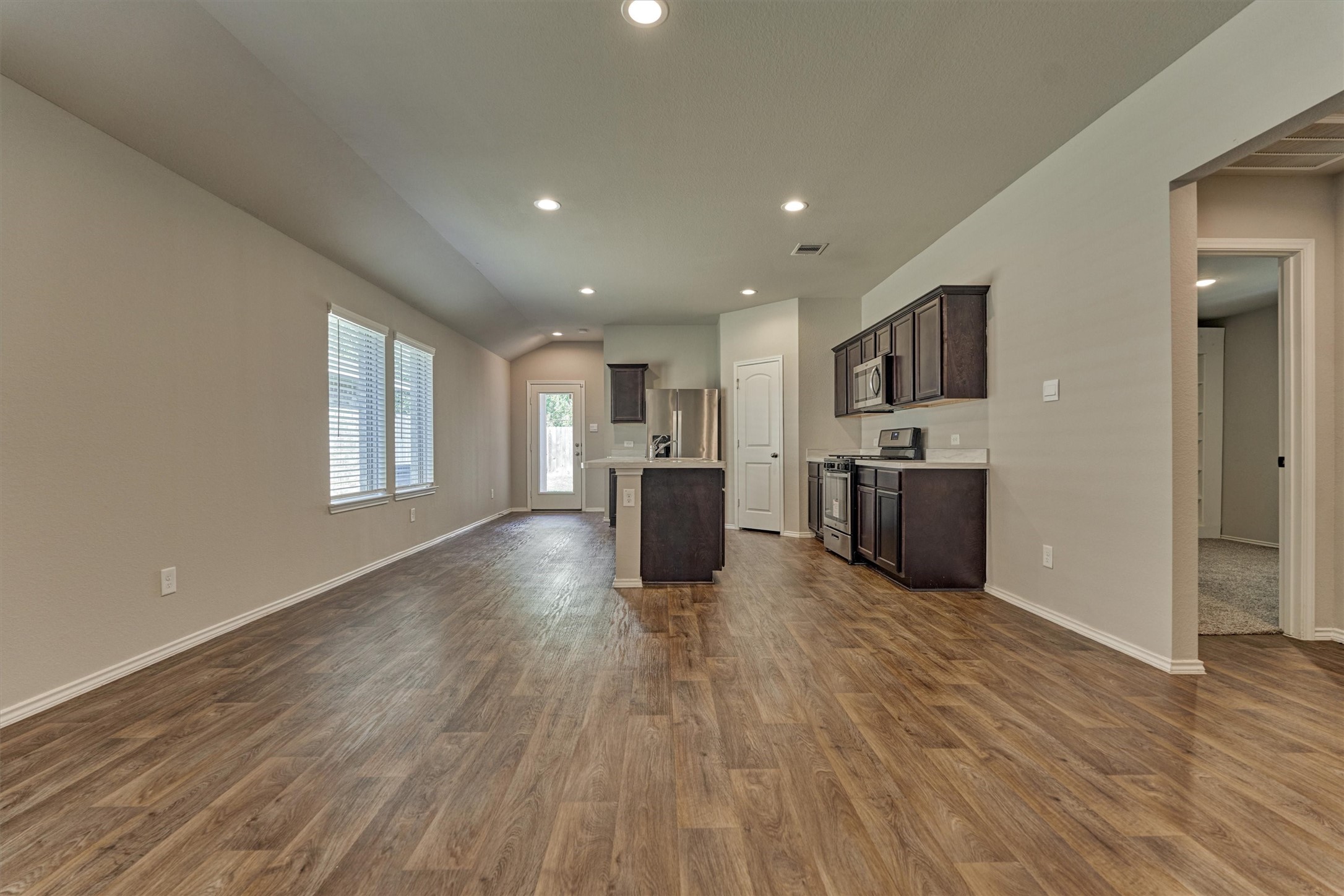 22630 Winter Maple Trail Spring, TX 77373 - Photo 11 of 31 a living room with stainless steel appliances kitchen island hardwood floor and a large window