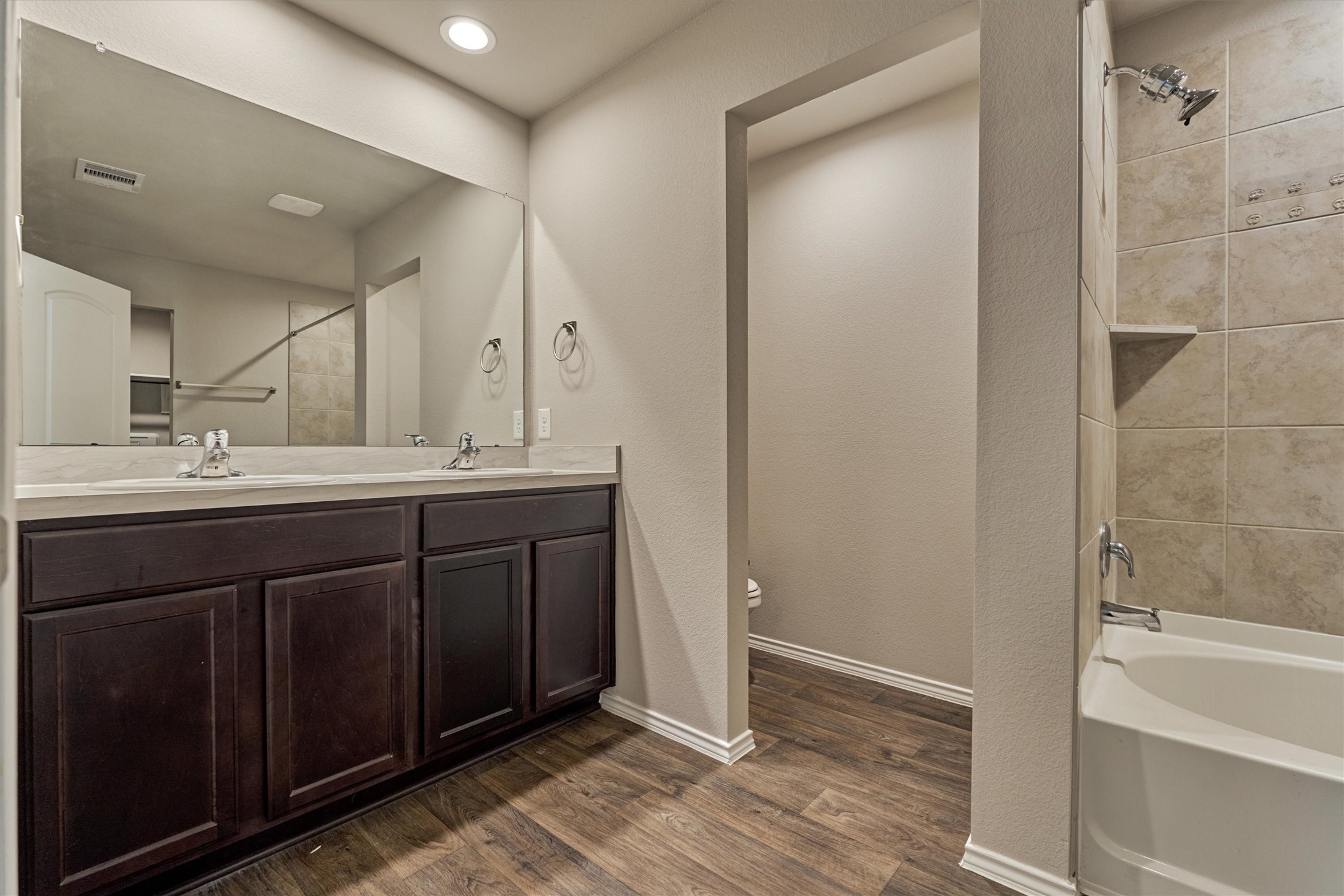 22630 Winter Maple Trail Spring, TX 77373 - Photo 19 of 31 a bathroom with a double vanity sink a mirror and a bathtub