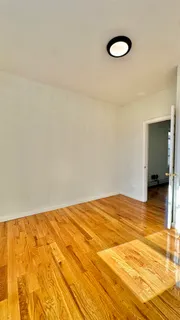 a view of a room with wooden floor and bathroom