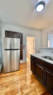 a kitchen with granite countertop a refrigerator and a sink