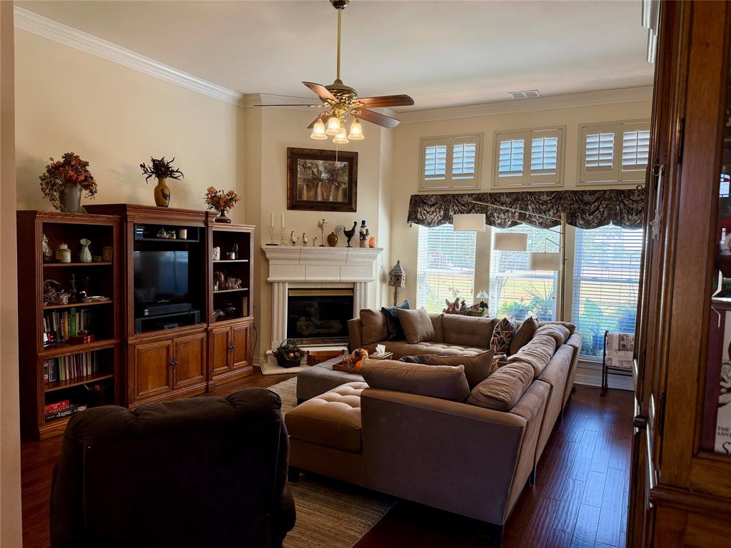 1333 East Highland Road Waxahachie, TX 75167 - Photo 6 of 33 a living room with furniture a flat screen tv and a fireplace