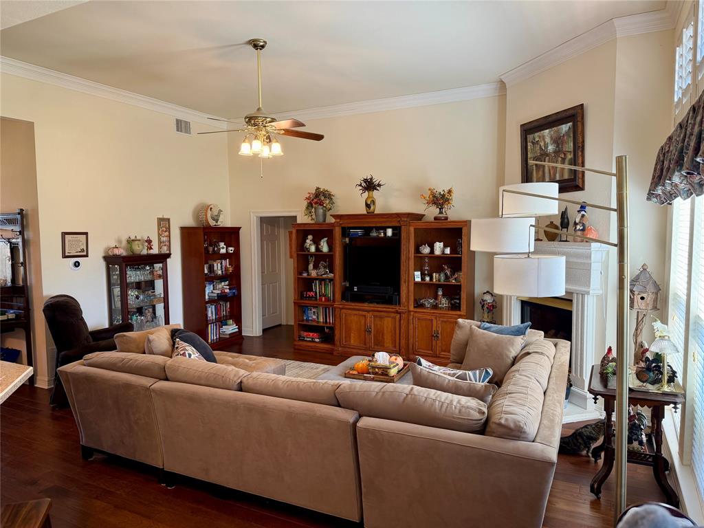1333 East Highland Road Waxahachie, TX 75167 - Photo 7 of 33 a living room with furniture a ceiling fan and a fireplace