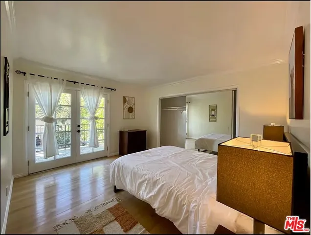 a spacious bedroom with a large bed and a large window