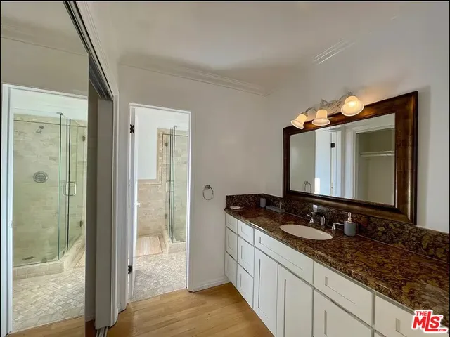 a bathroom with a double vanity sink and a mirror
