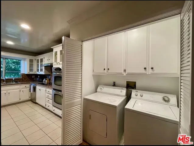 a kitchen with a white cabinets and white appliances