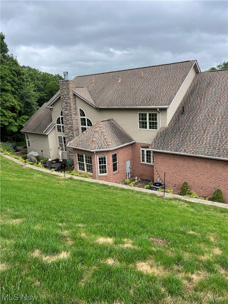 1457 Terrace Road Northwest New Philadelphia, OH 44663 - Photo 29 of 33 Back of house featuring a lawn