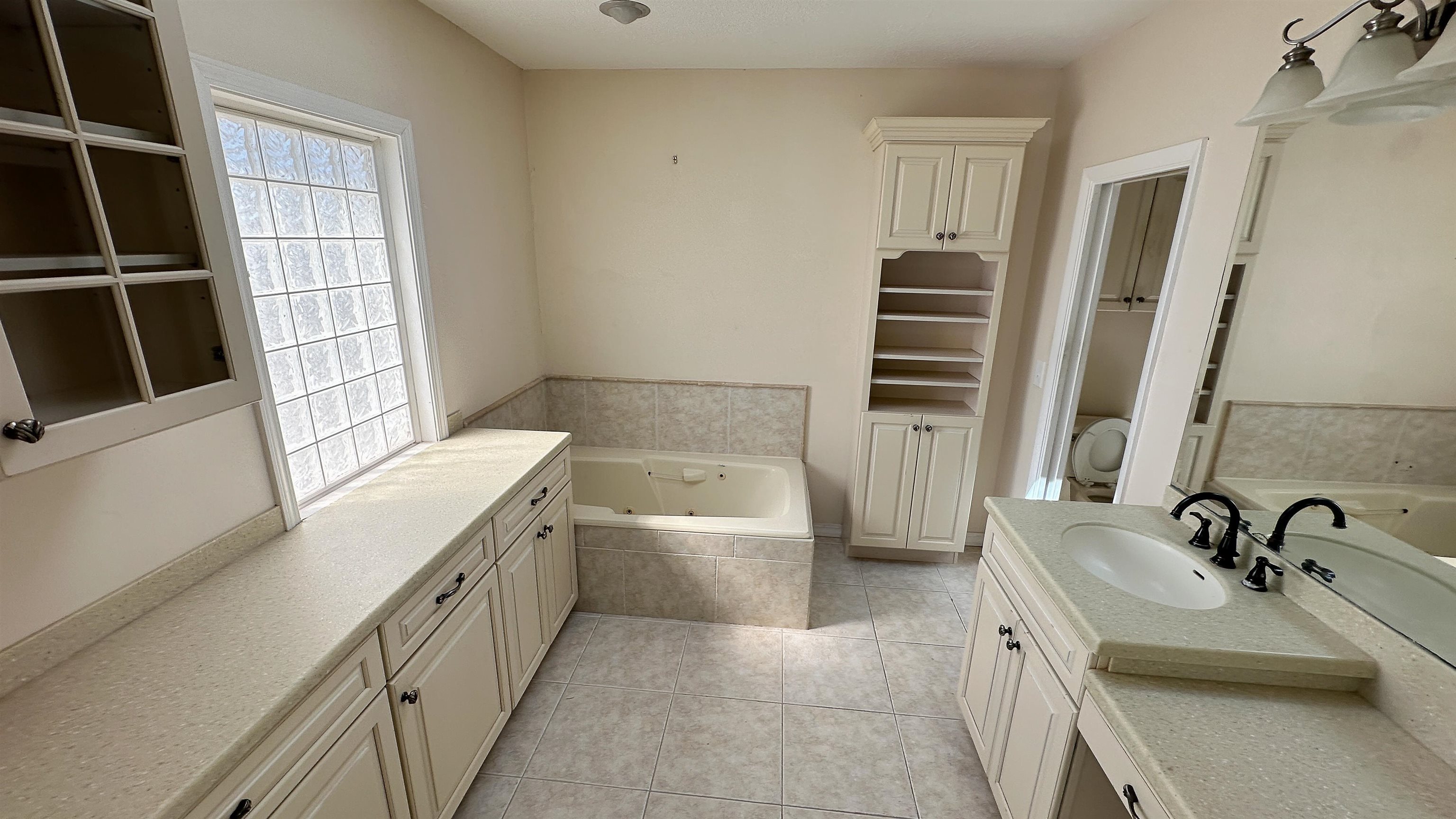 2 11th Street St. Augustine Beach, FL 32080 - Photo 2 of 72 Full bathroom with a whirlpool tub, light tile patterned floors, vanity, and a closet