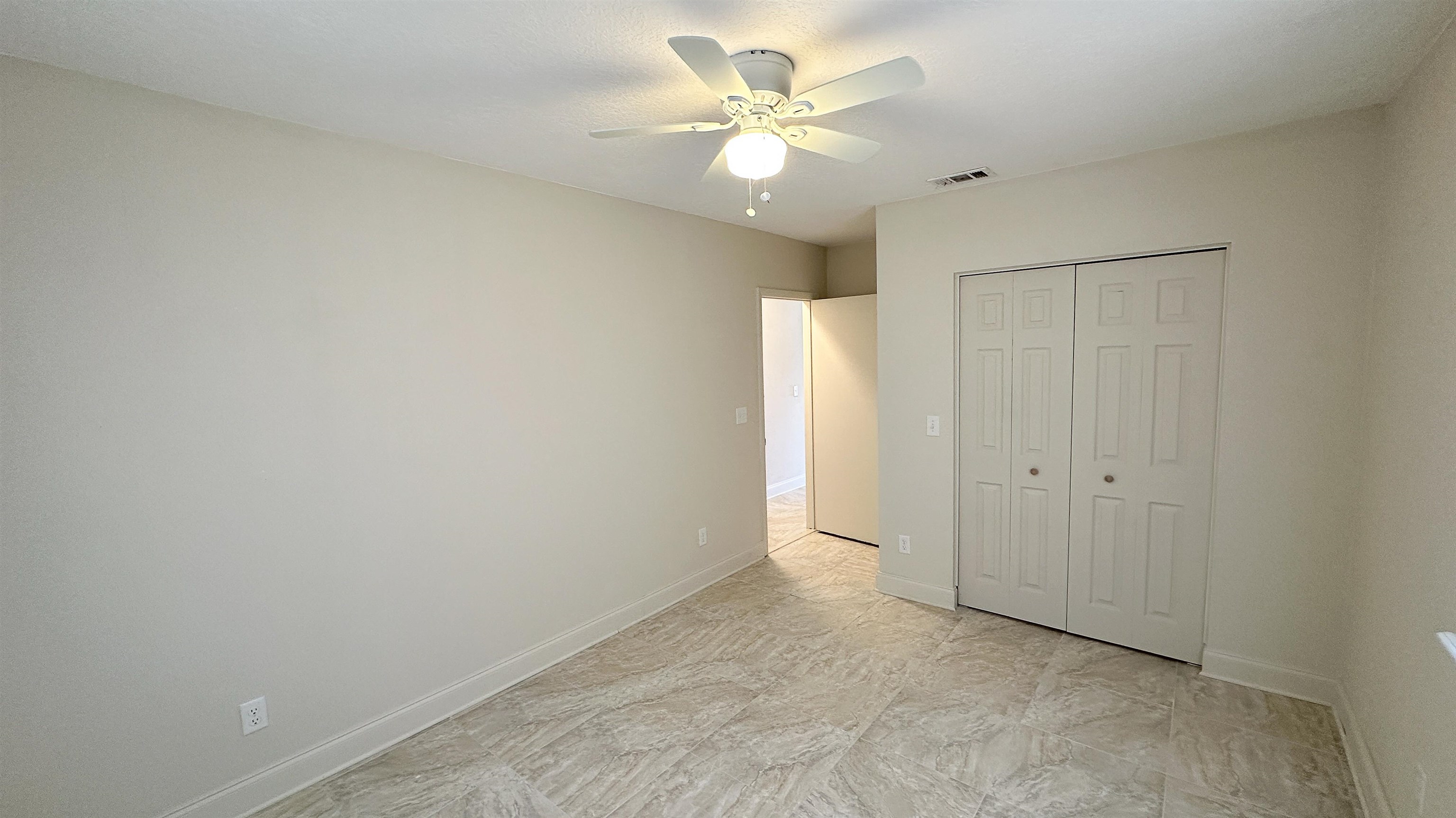 2 11th Street St. Augustine Beach, FL 32080 - Photo 50 of 72 Unfurnished bedroom featuring ceiling fan and a closet