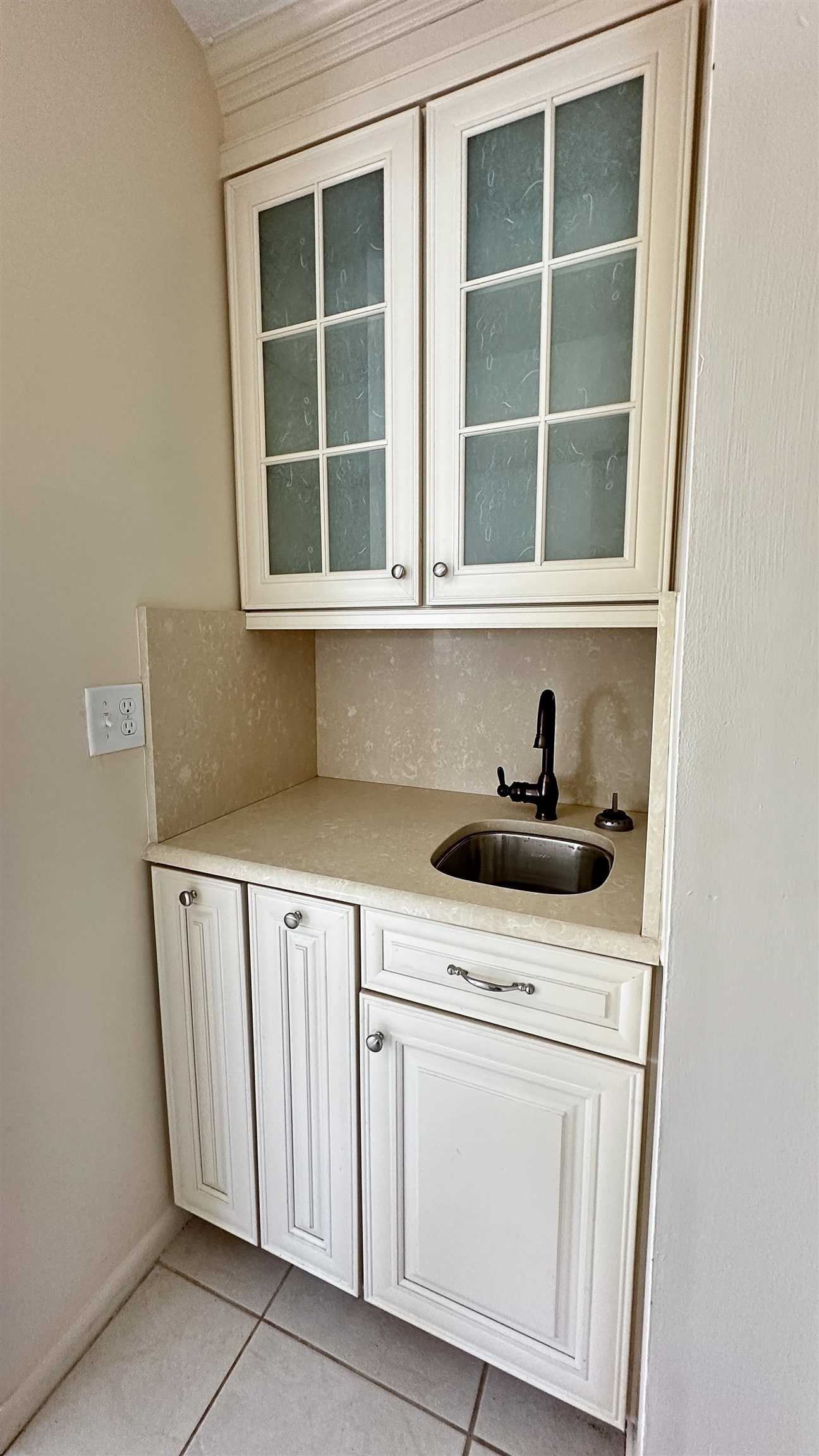 2 11th Street St. Augustine Beach, FL 32080 - Photo 57 of 72 Bar featuring glass insert cabinets, white cabinetry, light tile patterned floors, and light stone counters